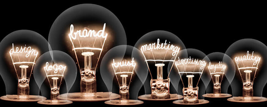 Photo of vintage light bulbs with BRAND and MARKETING concept related words on black background