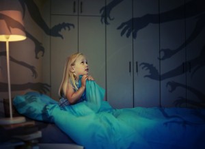 Nightmare idea, little girl in bed hiding from monster hands